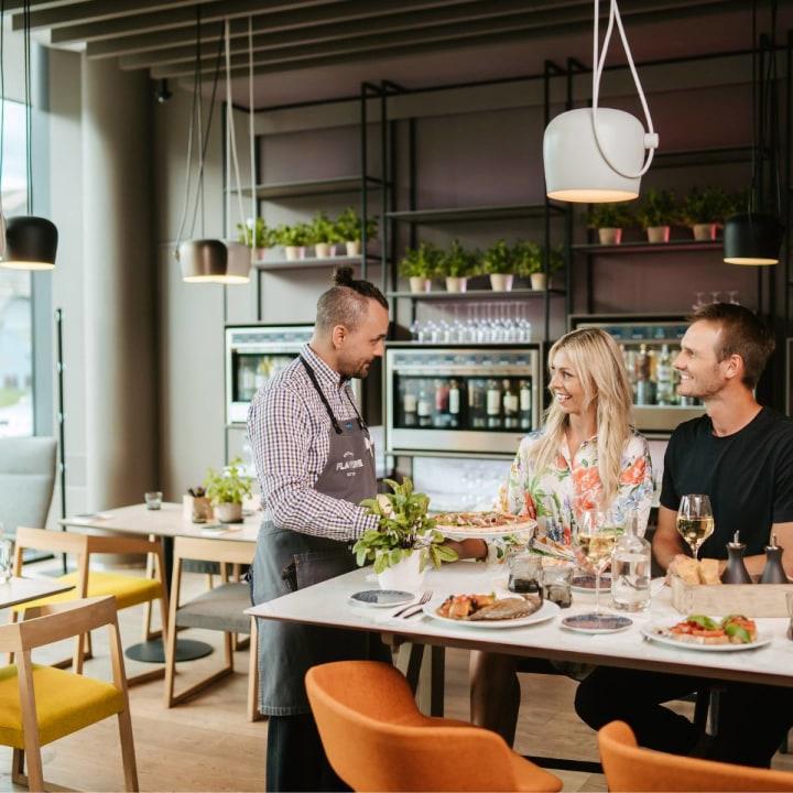 Waiter interacting with customers