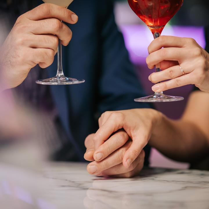 Couple holding hands at the table